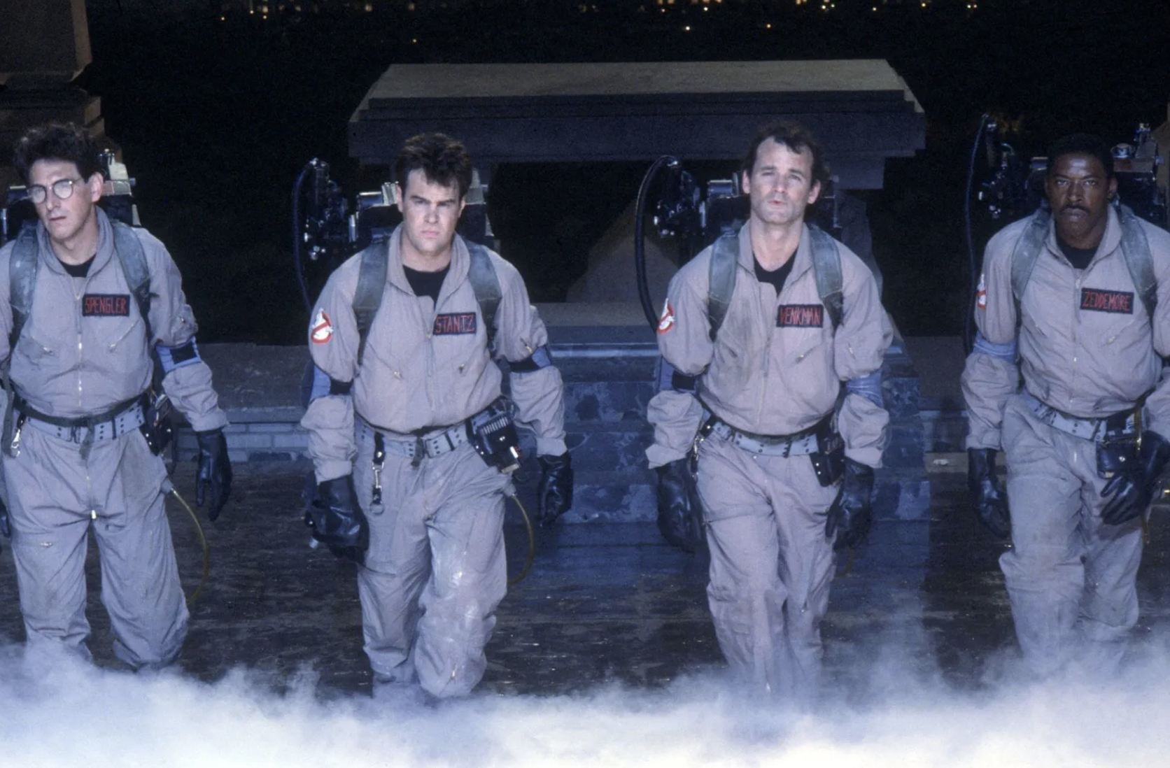 Harold Ramis, Dan Aykroyd, Bill Murray, and Ernie Hudson sport their ghost-busting uniforms in a still from “Ghostbusters,” which hit theaters in June 1984. 